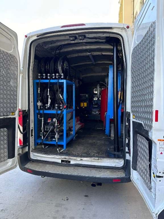 Van-mounted mobile workshop with hose reels and hydraulic tools